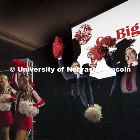 Under the direction of Debra Kleve White, Chancellor Ronnie Green, center, Bob Wilhelm, Vice Chancellor for Research and Economic Development, and members of the current cheer squad lead the crowd in "Go Big Red". Debra Kleve White, alumni and former member of the spirit squad, presents the Homecoming Nebraska Lecture, “Louise Pound and the History of UNL School Spirit”. October 4, 2019. Photo by Craig Chandler / University Communication.