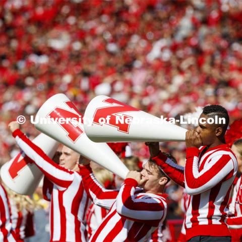 The male cheerleaders use their megaphones to rally the crowd. Nebraska vs. Northwestern University football game. Homecoming 2019. October 5, 2019.  Photo by Craig Chandler / University Communication.