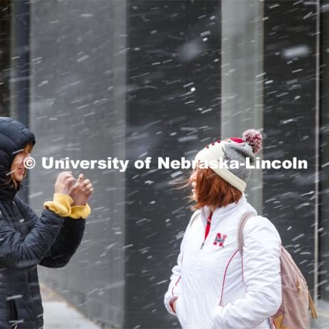 Two young women crossing campus in the snow. Snow on campus. October 30, 2019. Photo by Craig Chandler / University Communication.