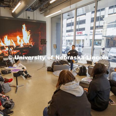 Hot learning on a cold day. Video of a fireplace takes the chill off as Jesse Fleming leads a discussion during his EMAR 140 - Visual Expression Studio course in the Johnny Carson Center for Emerging Arts. Snow on campus. October 30, 2019. Photo by Craig Chandler / University Communication.