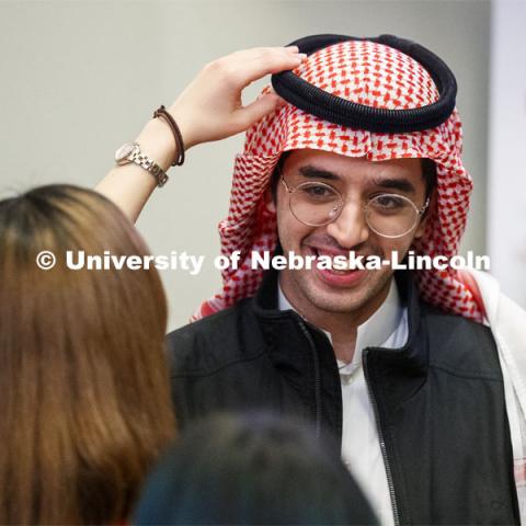 Abraham Al-Quasen, an international student from Saudi Arabia, has his headdress adjusted at the festival. Global Huskers Festival, a multicultural festival provides attendees the chance to explore the world through informational booths that will have food, cultural décor, art, and more, each hosted by UNL students from those culture. November 19, 2019. Photo by Craig Chandler / University Communication.