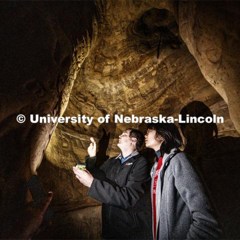 Professor Ricky Wood and PhD student Yijun Liao look over carvings in a side passage that connects to an air vent above their heads. The engineering professor uses LIDAR to digitally map Robbers Cave in Lincoln. November 22, 2019. Photo by Craig Chandler / University Communication.