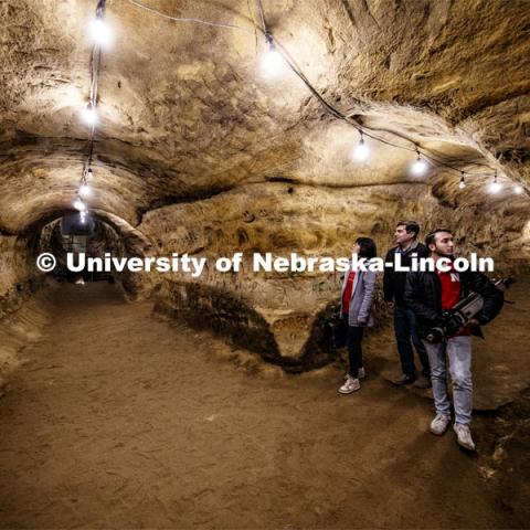 From left: Yijun Liao, Professor Ricky Wood and Dylan Downes carry their equipment through the cave after a mapping demonstration. The engineering professor uses LIDAR to digitally map Robbers Cave in Lincoln. November 22, 2019. Photo by Craig Chandler / University Communication.