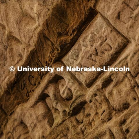 Names and drawings fill the walls of the cave. Professor Ricky Wood uses LIDAR to digitally map Robbers Cave in Lincoln. November 22, 2019. Photo by Craig Chandler / University Communication.