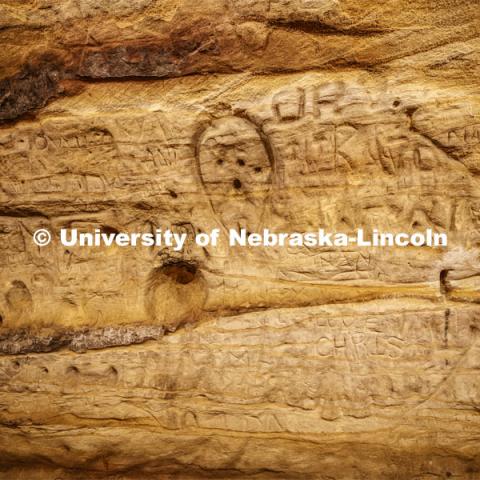 Names and drawings fill the walls of the cave. Professor Ricky Wood uses LIDAR to digitally map Robbers Cave in Lincoln. November 22, 2019. Photo by Craig Chandler / University Communication.