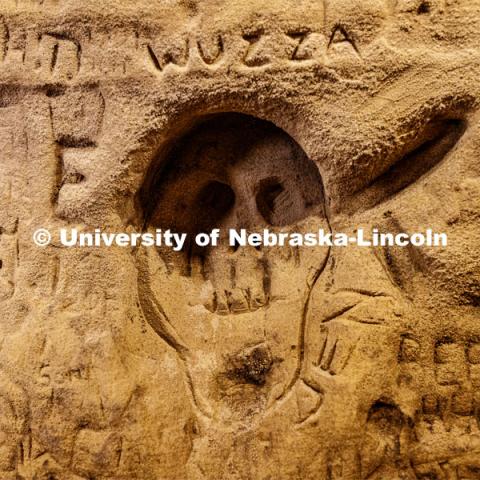 A face of a ghoul is among thousands of names carved on the sandstone walls. Professor Ricky Wood uses LIDAR to digitally map Robbers Cave in Lincoln. November 22, 2019. Photo by Craig Chandler / University Communication.