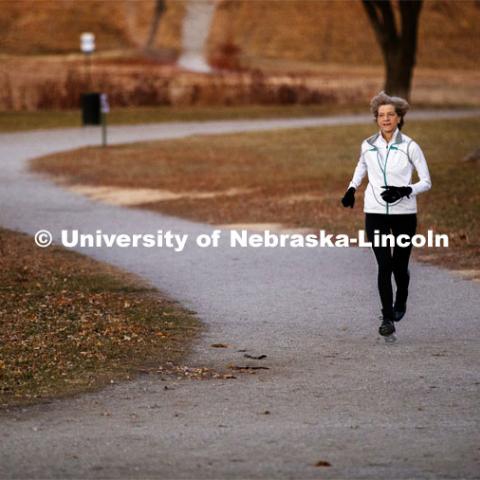 Sue Sheridan, director of the Nebraska Center for Research on Children, Youth, Families and Schools, is on a mission to run marathons or half-marathons in all 50 states. Sheridan is running in support of her nonprofit, Elevating Haitian Education. Sue is pictured running at Holmes Lake Park in Lincoln, Nebraska. December 4, 2019. Photo by Craig Chandler / University Communication.