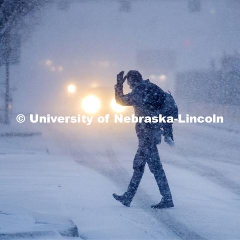Some Mondays are more Monday than others. Monday morning snowstorm. Person crossing the street in a snow storm. December 9, 2019. Photo by Craig Chandler / University Communication.