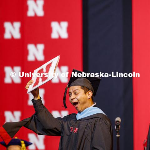 Hector de Jesus Palala Martinez celebrates his masters degree. Graduate Commencement and Hooding at the Pinnacle Bank Arena. December 20, 2019. Photo by Craig Chandler / University Communication.
