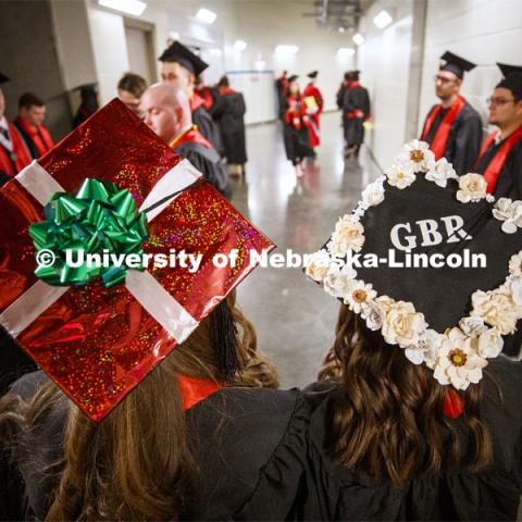 Ashley Willis and Kaylee Land show off their decorated mortar boards. December Undergraduate commencement at Pinnacle Bank Arena. December 21, 2019. Photo by Craig Chandler / University Communication.