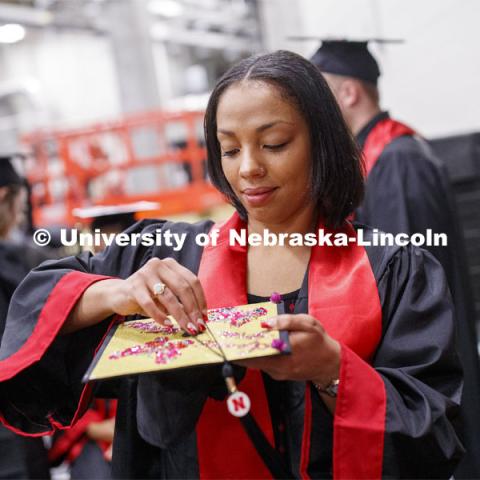 Kyiia Rollag puts her tassel on her mortar board Saturday morning. December Undergraduate commencement at Pinnacle Bank Arena. December 21, 2019. Photo by Craig Chandler / University Communication.