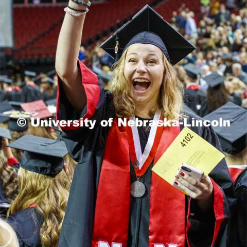 Molly Lambert waves to family and friends as she enters the arena. December Undergraduate commencement at Pinnacle Bank Arena. December 21, 2019. Photo by Craig Chandler / University Communication.