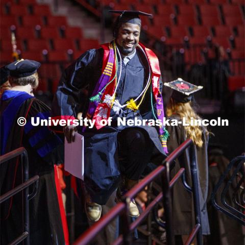 Pernell Jefferson celebrates by jumping for joy after he receives his CEHS degree. December Undergraduate commencement at Pinnacle Bank Arena. December 21, 2019. Photo by Craig Chandler / University Communication.