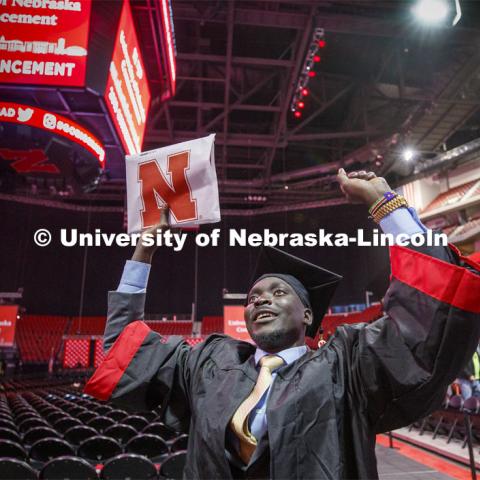 Septer Duang celebrates his degree with family and friends as he leaves the arena. December Undergraduate commencement at Pinnacle Bank Arena. December 21, 2019. Photo by Craig Chandler / University Communication.