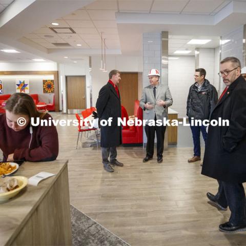 Ryan Lahne, interim director of the east campus union, (at center, wearing hard hat) discusses the new east campus dining center during the tour. NU President Ted Carter tours UNL campuses. January 16, 2020. Photo by Craig Chandler / University Communication.