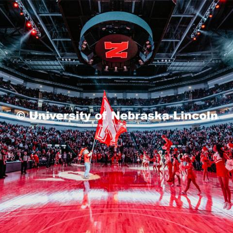 Herbie holds a large N flag while the spirit team rallies the crowd during the pregame light show. Nebraska vs. Wisconsin State University men’s basketball game. February 15, 2020. Photo by Justin Mohling / University Communication.