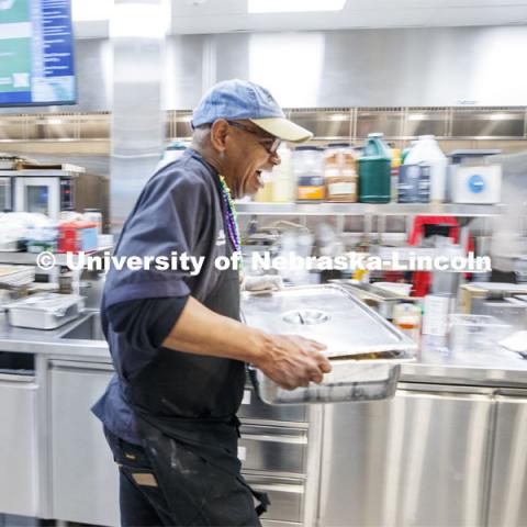 Ron White moves a hot pan of his special recipes through the dining center. Mardi Gras special meal at East Campus Dining Center. February 25, 2020. Photo by Craig Chandler / University Communication.