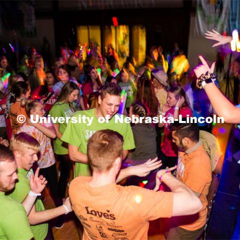 Students dancing in a "Rave"-like setting with glow lights and beach balls bouncing through the crowd. University of Nebraska–Lincoln students exceeded their goal, raising $235,229 during the annual HuskerThon on Feb. 29. Also known as Dance Marathon, the event is part of a nationwide fundraiser supporting Children’s Miracle Network Hospitals. The annual event, which launched in 2006, is the largest student philanthropic event on campus. The mission of the event encourages participants to, “dance for those who can’t.” All funds collected by the Huskers benefit the Children’s Hospital and Medical Center in Omaha. February 29, 2020. Photo by Justin Mohling / University Communication.