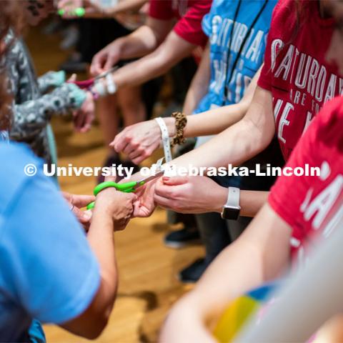 Students getting their symbolic wristbands cut off by miracle children. University of Nebraska–Lincoln students exceeded their goal, raising $235,229 during the annual HuskerThon on Feb. 29. Also known as Dance Marathon, the event is part of a nationwide fundraiser supporting Children’s Miracle Network Hospitals. The annual event, which launched in 2006, is the largest student philanthropic event on campus. The mission of the event encourages participants to, “dance for those who can’t.” All funds collected by the Huskers benefit the Children’s Hospital and Medical Center in Omaha. February 29, 2020. Photo by Justin Mohling / University Communication.