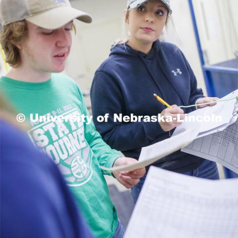 Lexie Schuster, senior in Animal Science from Elk Creek, NE, listens as her group finishes their documentation on their farrowing results. Students in ASCI 150 - Animal Production Skills. March 12, 2020. Photo by Craig Chandler / University Communication.