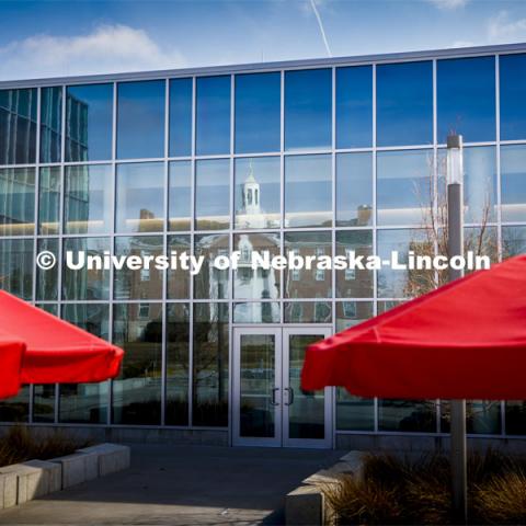 Neihart Hall is reflected in the new Willa Cather Dining Complex on City Campus. March 17, 2020. Photo by Craig Chandler / University Communication.