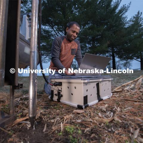 Nuwan Wijewardane, postdoctoral researcher in biological systems engineering, prepares to gather data from multiple locations by hydraulically plunging a penetrometer prototype into soil which is mounted to a Giddings probe truck. March 18, 2020. Photo by Gregory Nathan / University Communication.