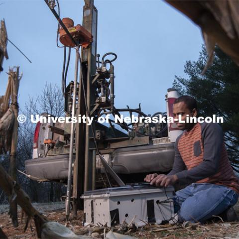 Nuwan Wijewardane, postdoctoral researcher in biological systems engineering, prepares to gather data from multiple locations by hydraulically plunging a penetrometer prototype into soil which is mounted to a Giddings probe truck. March 18, 2020. Photo by Gregory Nathan / University Communication.