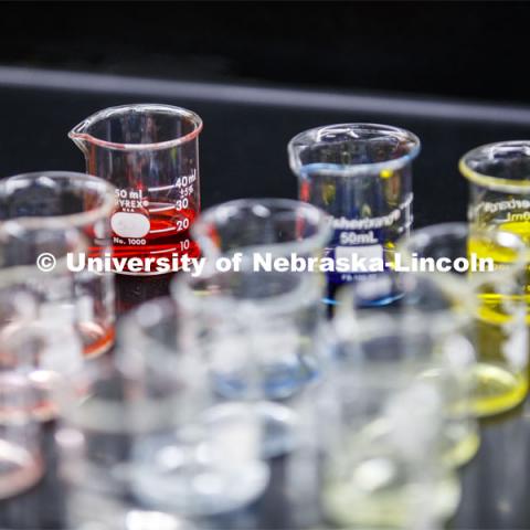Beakers of liquids for future labs await their turn in the spotlight. As a result of the Corona virus, Faculty are recording Chemistry labs in Hamilton Hall to prepare for the start of remote learning. March 24, 2020. Photo by Craig Chandler / University Communication.