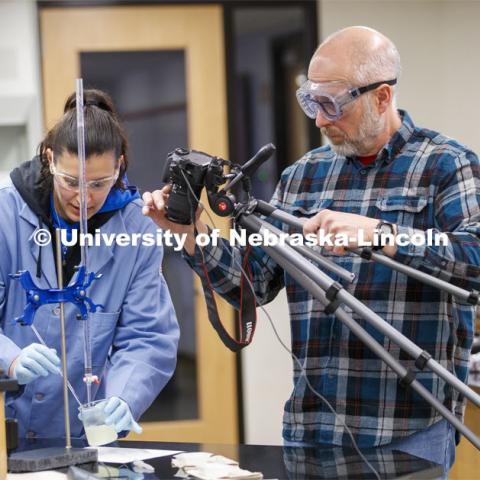 Jessica Periago, chemistry department lab manager, performs a Chem 110 lab as Kurt Wulser, chemistry department engineer, records the action. As a result of the Corona virus, Faculty are recording Chemistry labs in Hamilton Hall to prepare for the start of remote learning. March 24, 2020. Photo by Craig Chandler / University Communication.