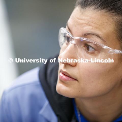 Jessica Periago, chemistry department lab manager, eyes the level of liquid in a burette during  chem 110 lab. As a result of the Corona virus, Faculty are recording Chemistry labs in Hamilton Hall to prepare for the start of remote learning. March 24, 2020. Photo by Craig Chandler / University Communication.