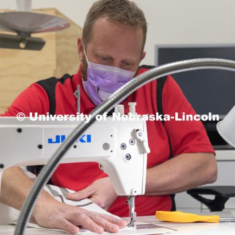 Jerry Reif, shop manager at Nebraska Innovation Studio, cuts hospital gowns from Tyvec material house wrap. The gowns are being assembled for hospitals in Nebraska in response to COVID-19. April 9, 2020. Photo by Gregory Nathan / University Communication.