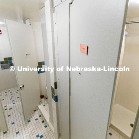 Sinks, toilets and shower stalls are labeled by room number to ensure privacy and cleanliness. To enable first responders and medical personnel to self-isolate while still working, Harper Residence Hall will be used to house them. Resident Hall Custodians are being trained to use PPE and safely clean the residence hall. April 10, 2020. Photo by Craig Chandler / University Communication.