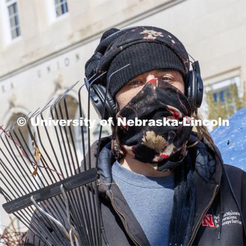 Ryan LaBenz, a Landscape Service student worker, wears a mask while working outside the Nebraska Union. He is one of many students still working on campus. April 13, 2020. Photo by Craig Chandler / University Communication.