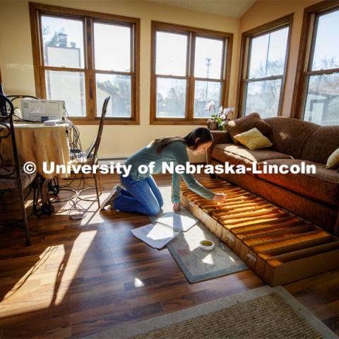 Mackenzie Zwiener, graduate student in agronomy, works with sorghum seeds in her family home in Lincoln. Zwiener is designating random plot labels to the varieties for the spring planting. Research continues as the work moves off campus. April 14, 2020. Photo by Craig Chandler / University Communication.