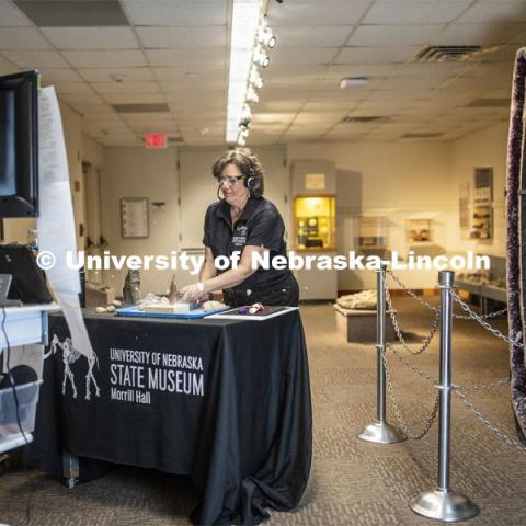 Annie Mumgaard, Virtual Learning Coordinator for the University Museum, uses a hammer to smash a geode to show the virtual students the inside of the rock. April 14, 2020. Photo by Craig Chandler / University Communication.