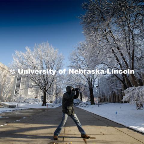 Chad Davis with Nebraska Educational Television takes a photo walk on city campus Friday morning. An April snowstorm leaves campus unseasonably beautiful. April 17, 2020. Photo by Craig Chandler / University Communication.