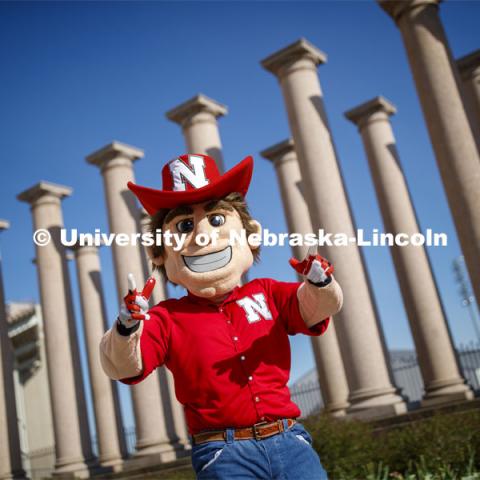 Herbie Husker in front of the columns by Memorial Stadium. On campus. April 30, 2020. Photo by Craig Chandler / University Communication.