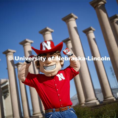 Herbie Husker in front of the columns by Memorial Stadium. On campus. April 30, 2020. Photo by Craig Chandler / University Communication.