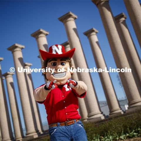 Herbie Husker in front of the columns by Memorial Stadium. On campus. April 30, 2020. Photo by Craig Chandler / University Communication.