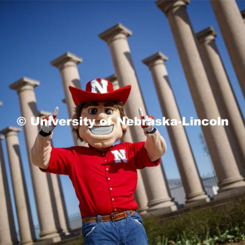 Herbie Husker in front of the columns by Memorial Stadium. On campus. April 30, 2020. Photo by Craig Chandler / University Communication.