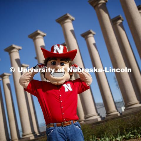 Herbie Husker in front of the columns by Memorial Stadium. On campus. April 30, 2020. Photo by Craig Chandler / University Communication.