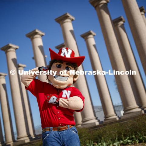 Herbie Husker in front of the columns by Memorial Stadium. On campus. April 30, 2020. Photo by Craig Chandler / University Communication.