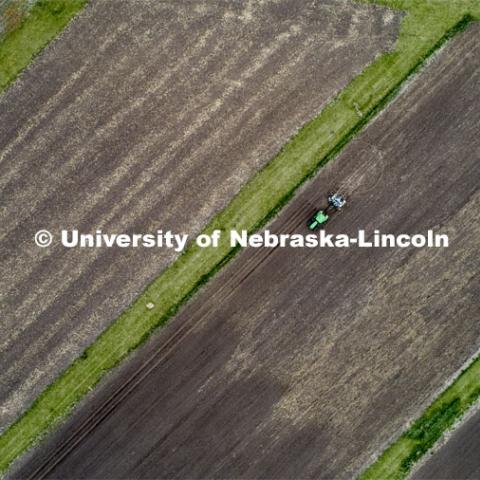 James Schnable corn research group plants at agronomy fields at 84th and Havelock in northeast Lincoln. Schnable’s lab studies grain DNA to find the best varieties for breeding and genetic modification to help with traits including yields and drought resistance. The 2.5-acre plot was being planted with 752 genotypes in 1680 precisely randomized plots. To plant those plots along with a check genotype, the researchers used 1860 packets of seeds manually poured into a hopper every 7 seconds while sitting atop a custom research planter. May 6, 2020. Photo by Craig Chandler / University Communication.