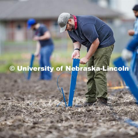 James Schnable and his group hand plants corn and sorghum seeds at the East Campus ag fields. May 20, 2020. Photo by Craig Chandler / University Communication.