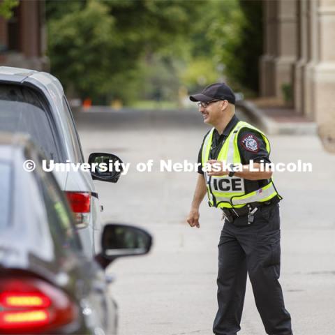 UNL Police direct the huge traffic flow for people coming for the free flat of flowers left from the Horticulture Club Plant Sale. May 21, 2020. Photo by Craig Chandler / University Communication.