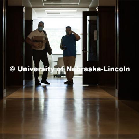 Jack Dohrman, Interim University Space Manager, Facilities Management and Planning, and Shawn Languis, Space Planning/GIS Data Coordinator with Facilities Management and Planning, move to the next room in Avery Hall. A group is physically measuring every classroom on campus to see if computer-aided predictions are correct. June 1, 2020. Photo by Craig Chandler / University Communication.