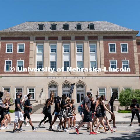 Protestors walk past the south entrance of the Nebraska Union during their march to the Nebraska State Capitol on Saturday, June 13th, 2020, in Lincoln, Nebraska. Black Lives Matter Protest. Photo by Jordan Opp for University Communication.