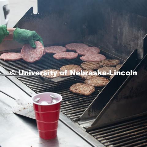 A grill full of pork burgers gets cooked up for the Lincoln City Mission. The pork, donated by pig farmer and University of Nebraska–Lincoln animal science alumnus, Bill Luckey, was the result of generosity, ingenuity, collaboration and a spirit of Nebraskans helping Nebraskans among the state’s pork producers, the Food Bank of Lincoln and the University of Nebraska–Lincoln. June 18, 2020. Photo by Gregory Nathan / University Communication.