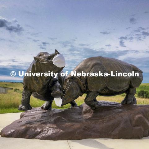 Ashfall rhinos, a sculpture by artist Gary Staab our outfitted with masks to welcome visitors to Ashfall Fossil Beds State Historical Park. Ashfall Fossil Beds State Historical Park in north central Nebraska. August 2, 2019. Photo provided.