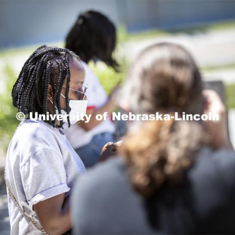 Sandhya Karki wears a mask while hanging out with friends. Photo shoot of students wearing masks and practicing social distancing. June 24, 2020. Photo by Craig Chandler / University Communication.